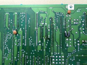 Commodore 64 Zero Insertion Force (ZIF) socket mod. C64 Assy 250469 board modified with ZIF sockets for easy IC chip testing. Backside of the board. A few chips had to be replaced to the backside of the motherboard.